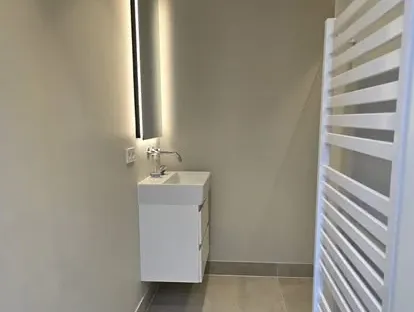 Maatwerk sanitair en tegelwerk in een gerenoveerde badkamer.
