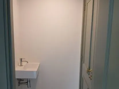 Badkamerrenovatie met zorgvuldig afgestemd sanitair, tegelwerk en verlichting.