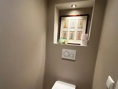 Badkamerrenovatie met zorgvuldig afgestemd sanitair, tegelwerk en verlichting.