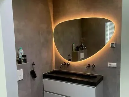 Maatwerk sanitair en tegelwerk in een gerenoveerde badkamer.