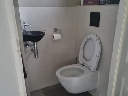 Maatwerk sanitair en tegelwerk in een gerenoveerde badkamer.