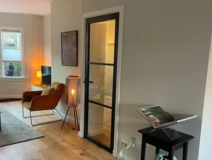 Badkamerrenovatie met zorgvuldig afgestemd sanitair, tegelwerk en verlichting.