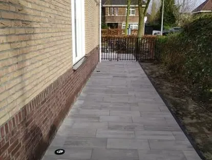 Vernieuwde buitenruimte en gevelafwerking bij een woningrenovatie.